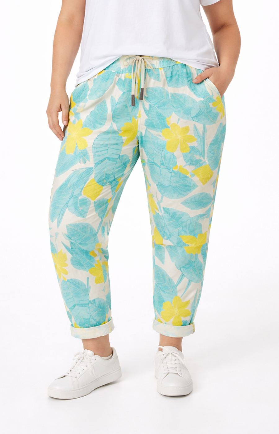 Person wearing floral-patterned pants on a white background