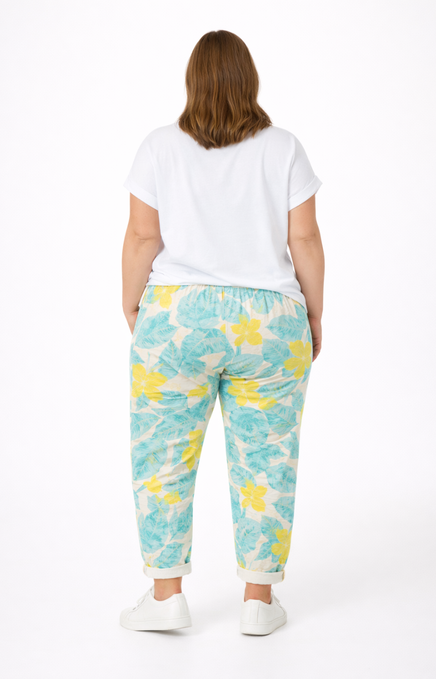 Person wearing a white t-shirt and blue and yellow tie-dye pants on a white background