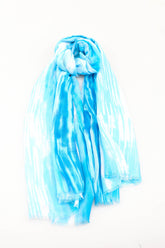 Blue and white tie-dye scarf on a white background