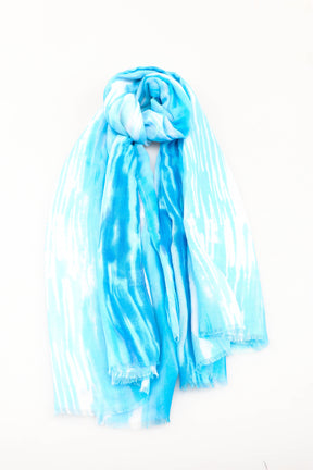 Blue and white tie-dye scarf on a white background