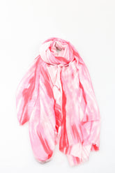 Pink and white tie-dye scarf on a white background