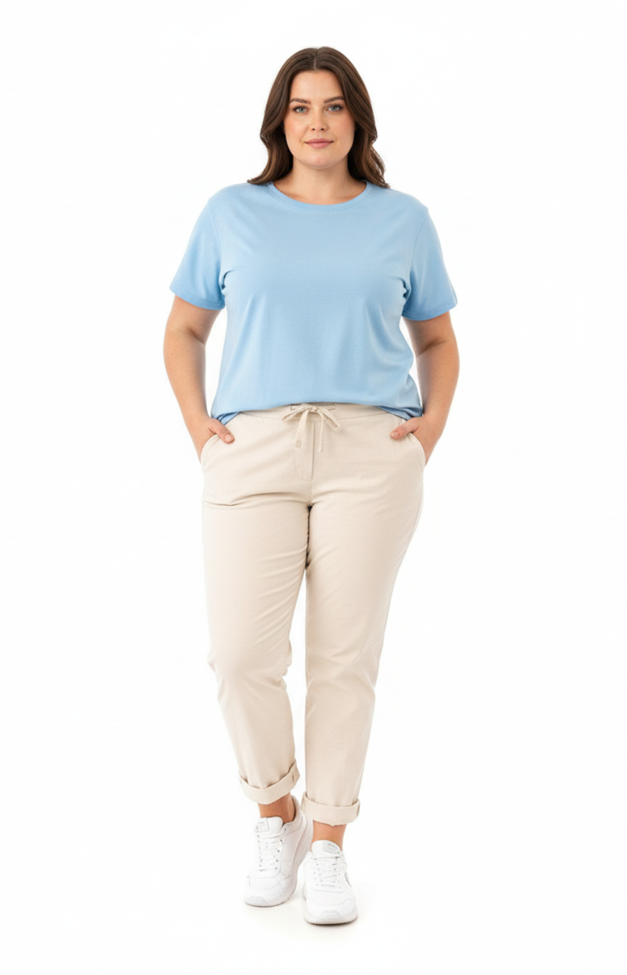 Plus size woman wearing beige pants and a light blue top on a white background