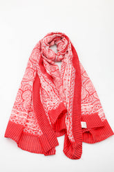 Red scarf with white patterns on a white background