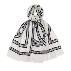 White scarf with black geometric pattern on a white background