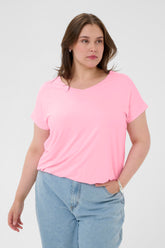 Woman wearing a pink t-shirt and blue jeans on a white background