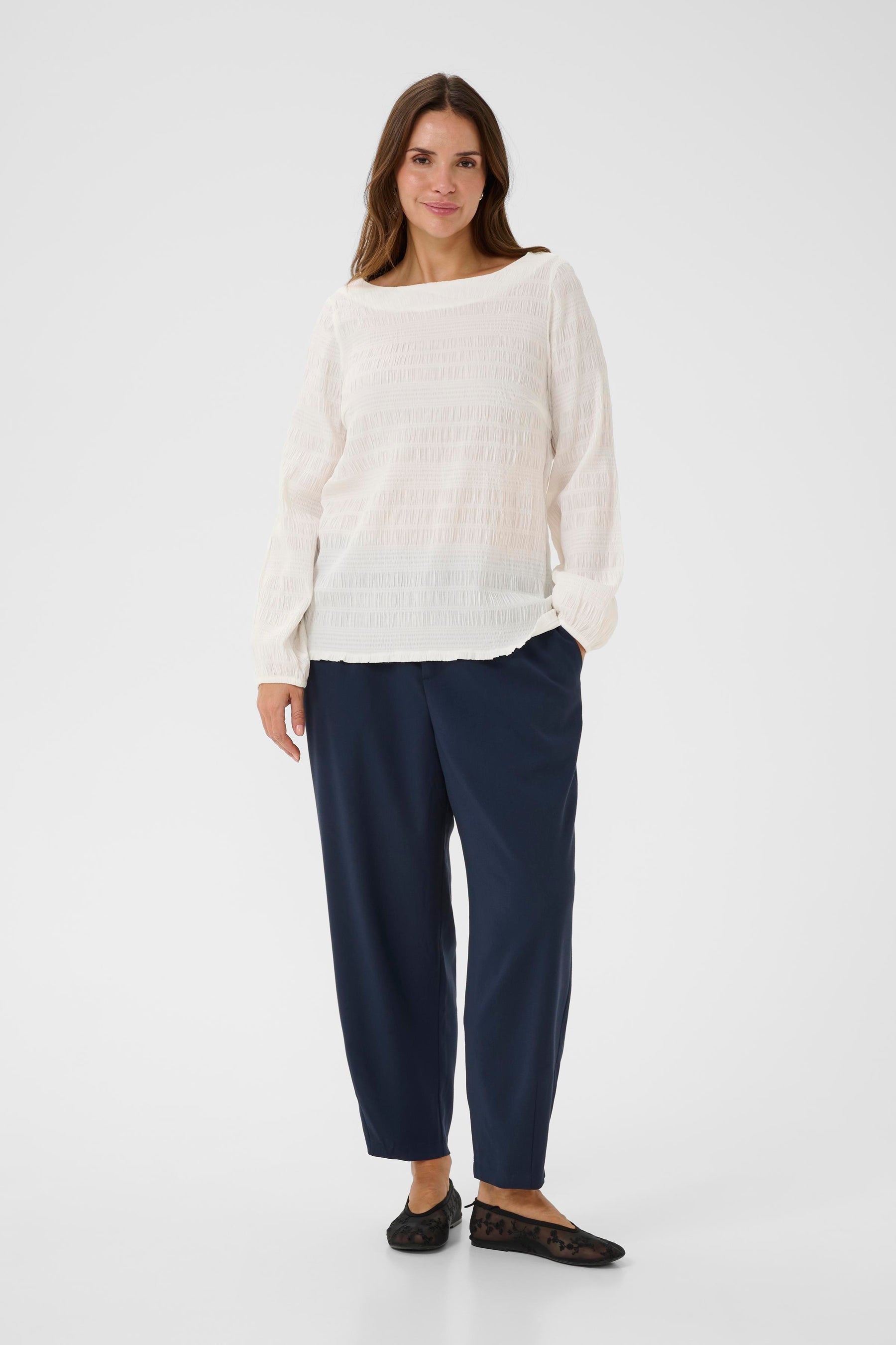 Kaffe Curve Jourtney Blouse in White, a long sleeves blouse with a boat neckline and has a textured, crepe like material 