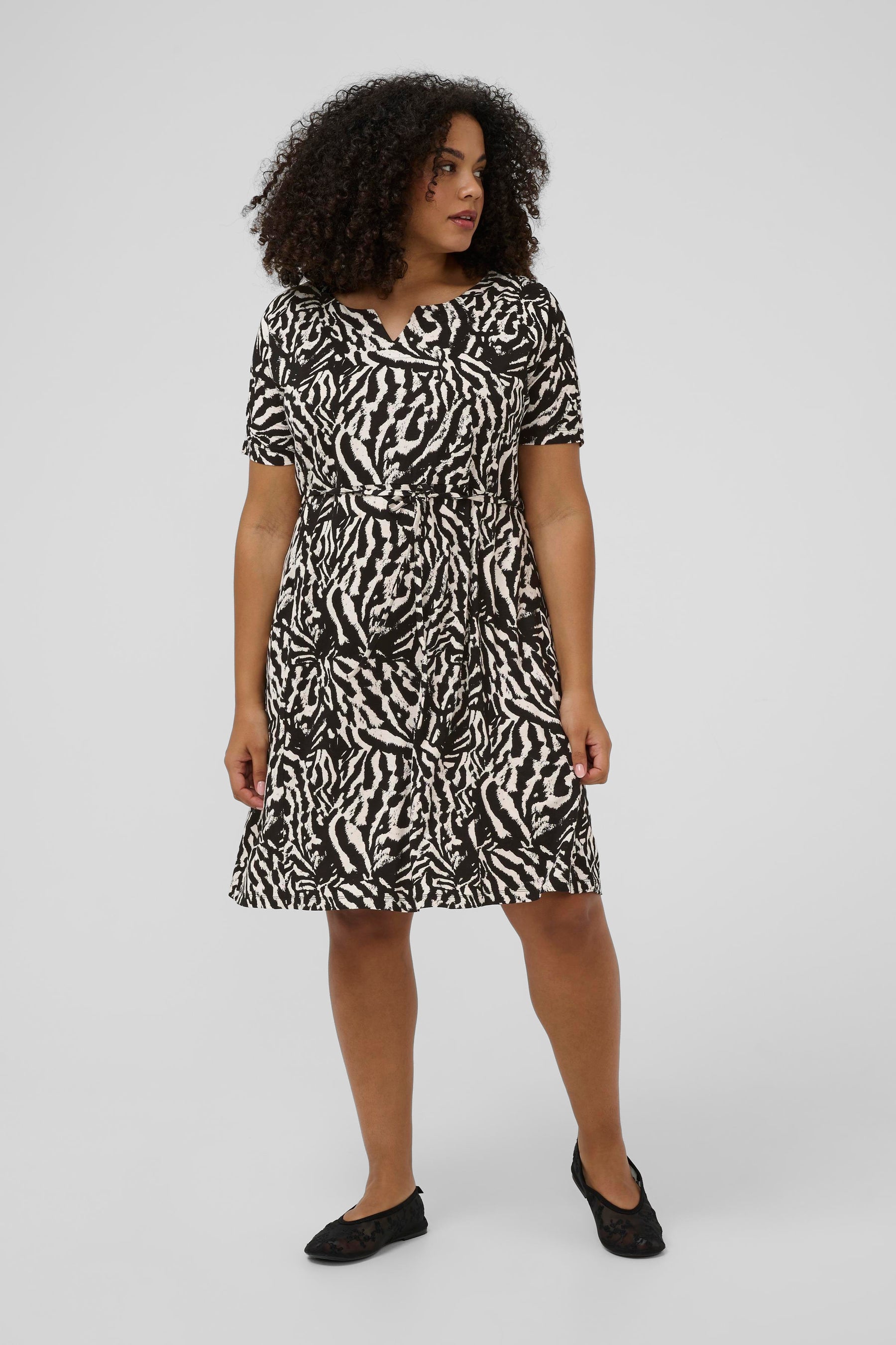 Knee length Kaffe Curve Mella Dress in Black and White animal print with a removable tie belt at the waist, Short sleeves and a rounded V neckline