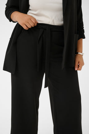 Kaffe Curve Pheolo Trousers in Black, side pockets and a built in tie belt, styled with a white top and matching blazer 