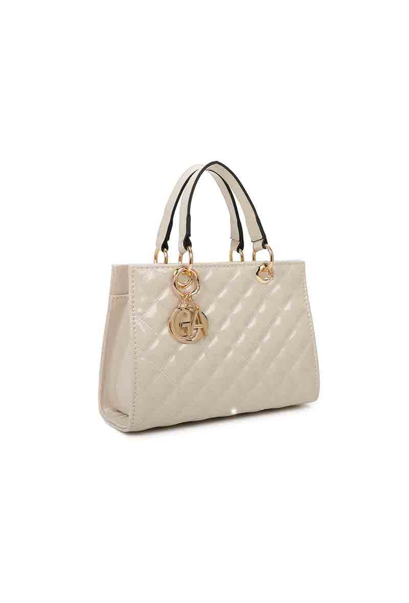Beige quilted handbag with a gold logo charm on a white background