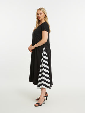 Woman wearing the Mat Black Dress with Side Stripes, a black, A-line midi dress with short sleeves and a round neckline with a white stripe design on each side, on a white background 