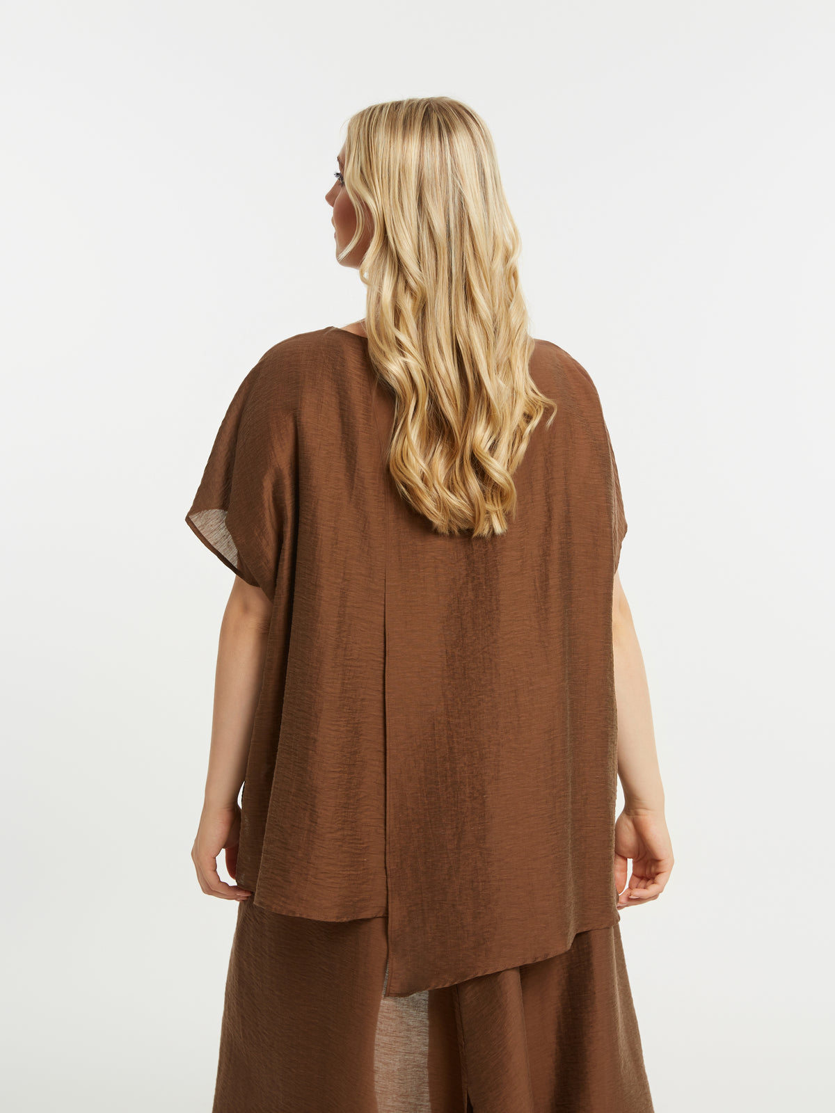 Woman wearing a brown outfit on a white background