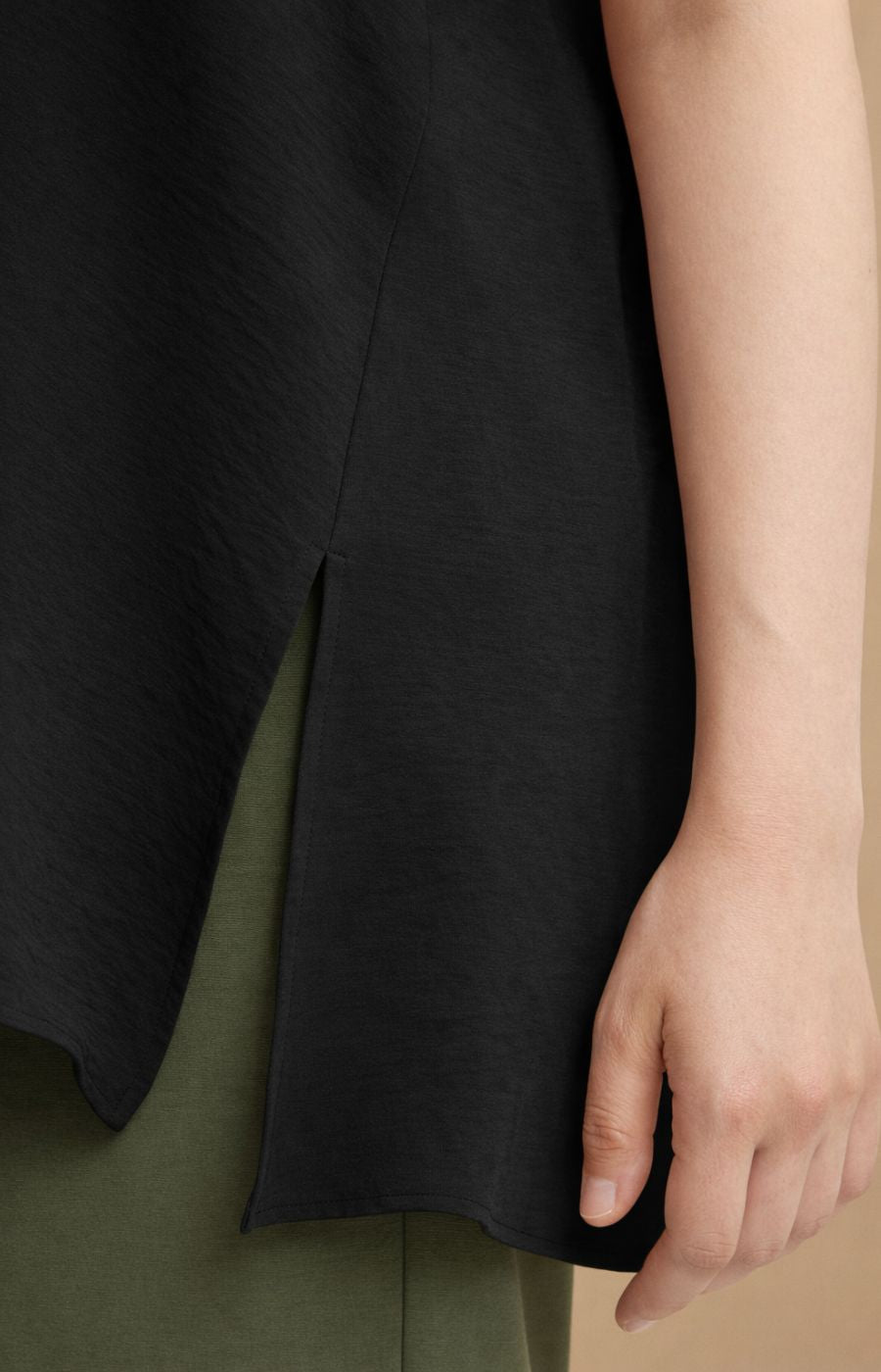 Close up of the side slit and curved hem of the Mat Cami in Black