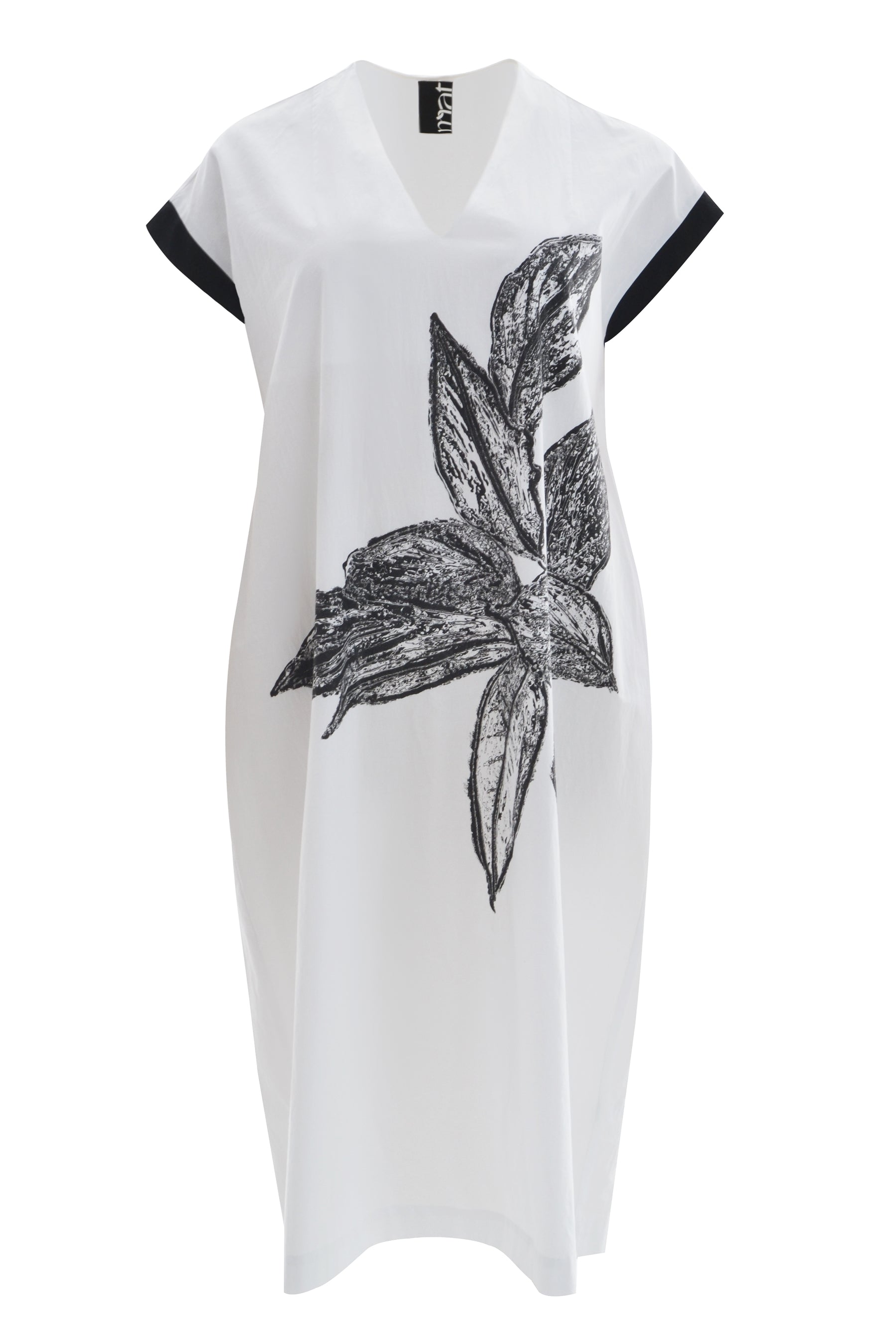White dress with black floral design on a white background
