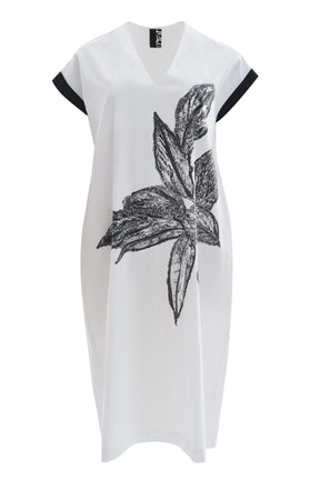 White dress with black floral design on a white background