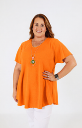 Woman wearing an orange blouse on a white background