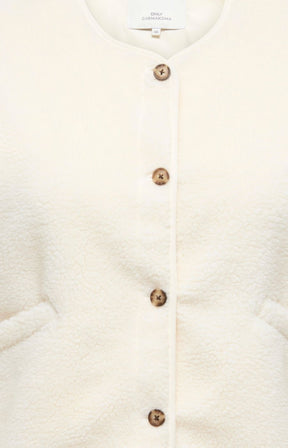 Close-up of the Only Carmakoma Baby Gilet in Cream, a cream-colored textured cardigan featuring a vertical row of tortoise shell buttons down the front.