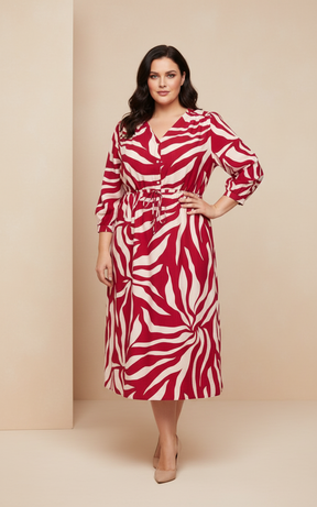 Woman wearing a red and white patterned dress against a beige background