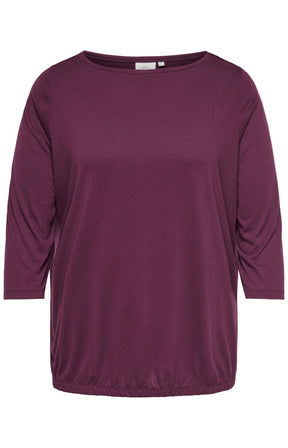 Only Carmakoma Carlinne Top in Fig, A women's three-quarter sleeve top in a deep plum purple color, featuring a wide boat neckline and a relaxed, slightly gathered silhouette, shown against a plain white background.