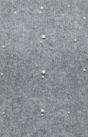 Close-up of a gray knit fabric with small pearl-like embellishments spaced vertically down the front on the Only Carmakoma Dolly Top in Grey.