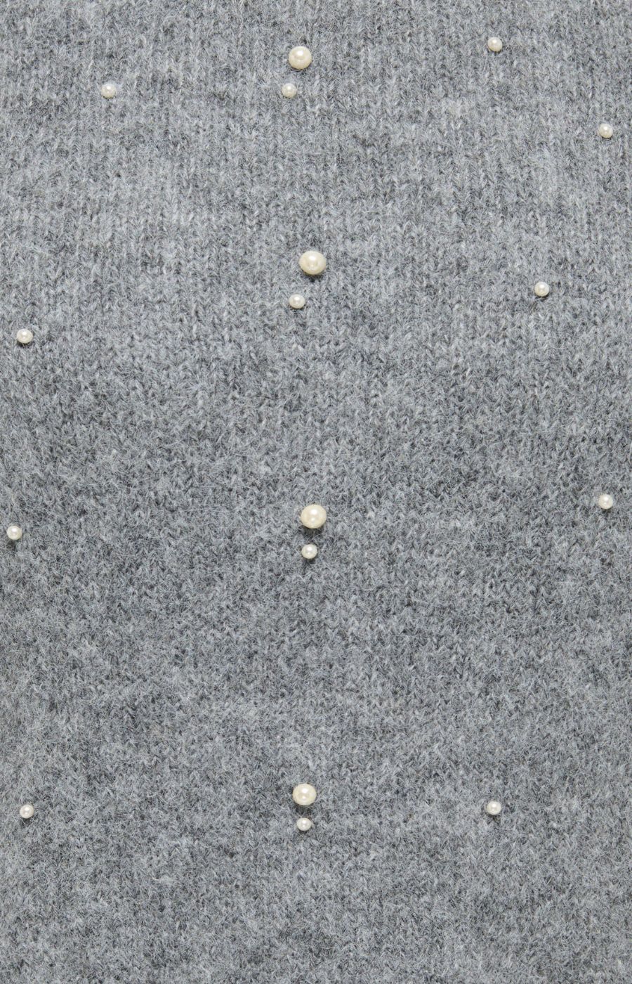 Close-up of a gray knit fabric with small pearl-like embellishments spaced vertically down the front on the Only Carmakoma Dolly Top in Grey.