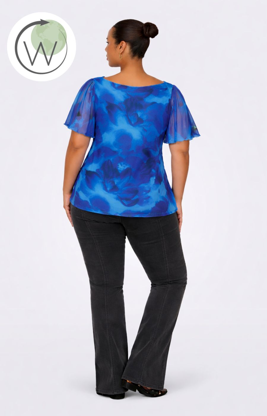 Woman wearing the Only Carmakoma Forest Top in Blue, a blue patterned top and black pants on a white background
