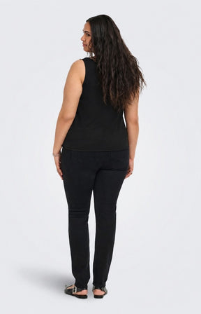 A woman with long dark hair is shown from the back wearing the Only Carmakoma Iris Vest Top in Black, a black sleeveless top and black pants against a light gray studio background. This image was created using AI.