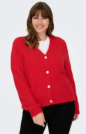 Only Carmakoma Maggie Cardigan in Red, a red knit cardigan with gold buttons, V neckline, long sleeves, faux pockets, ribbed edging, worn with jeans 