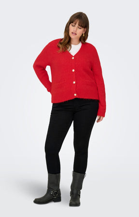 Women wearing a Only Carmakoma Maggie Cardigan in Red, black pants, and gray boots on a white background