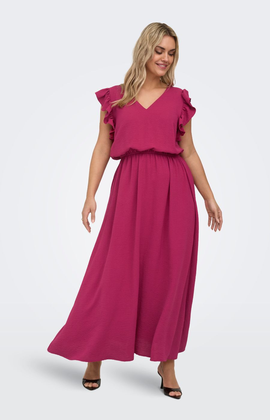 Woman wearing the Only Carmakoma Metta Dress in Wine, a maxi length dress with a V neckline, ruffled sleeves and an elasticated waistband on a white background