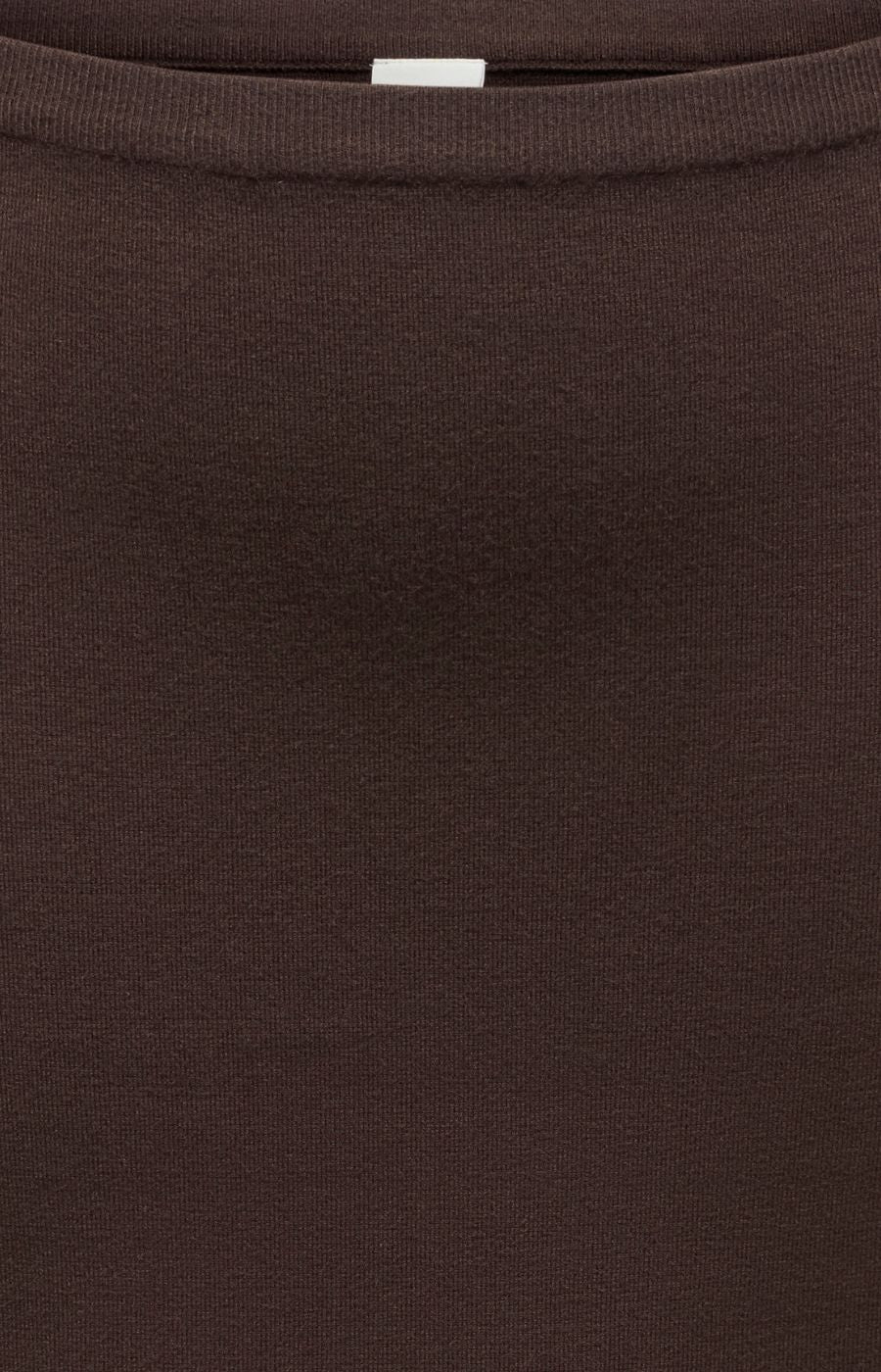 Close-up of the Only Carmakoma Ribi Skirt in Brown, a dark brown ribbed waist, knit skirt, showing the texture and colour.
