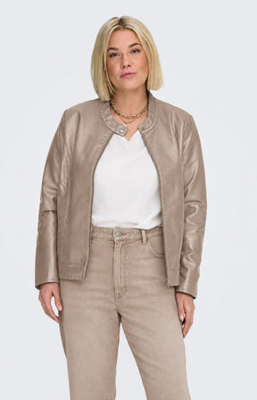 A woman modeling the Only Carmakoma Robber Faux Leather Jacket in Walnut, a light taupe faux-leather jacket with a zippered front, buttoned collar, and side pockets, paired with a white top and matching taupe pants against a light gray background. This image has be created using AI.