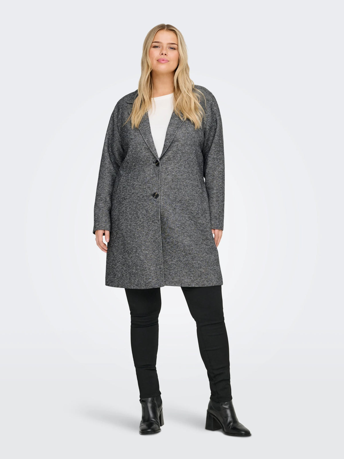 Woman wearing a gray coat on a white background