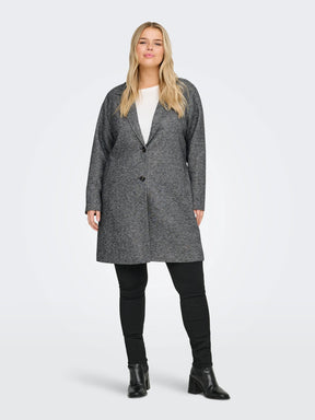 Woman wearing a gray coat on a white background