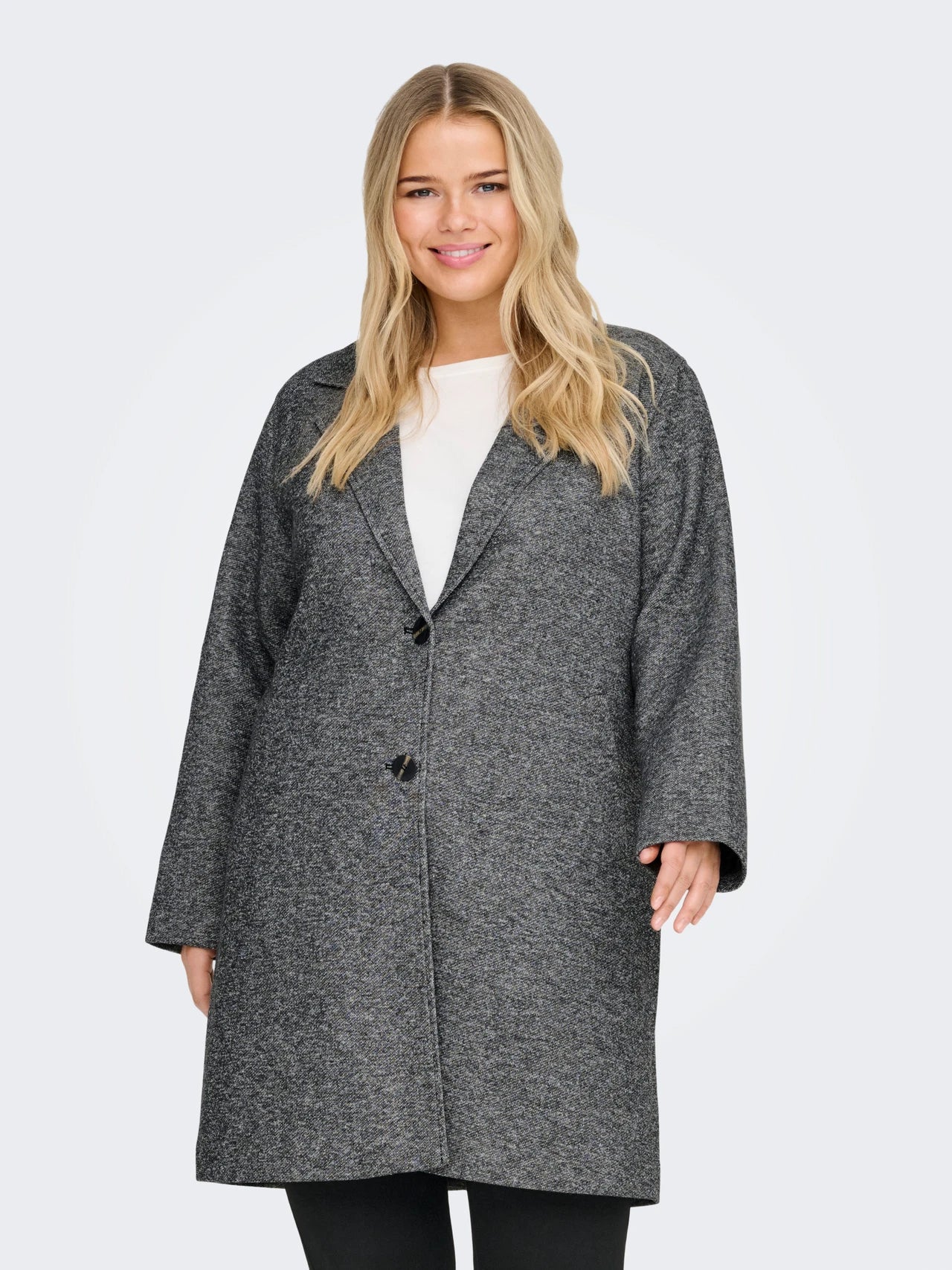 Woman wearing a gray coat on a light gray background