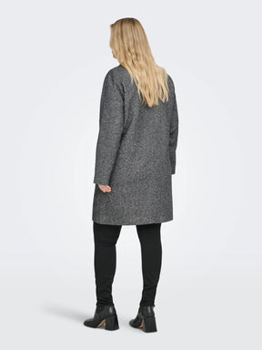 Woman wearing a gray coat on a white background