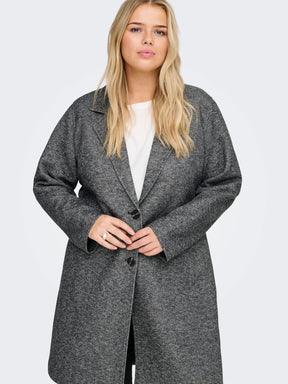 Woman wearing a gray coat on a white background