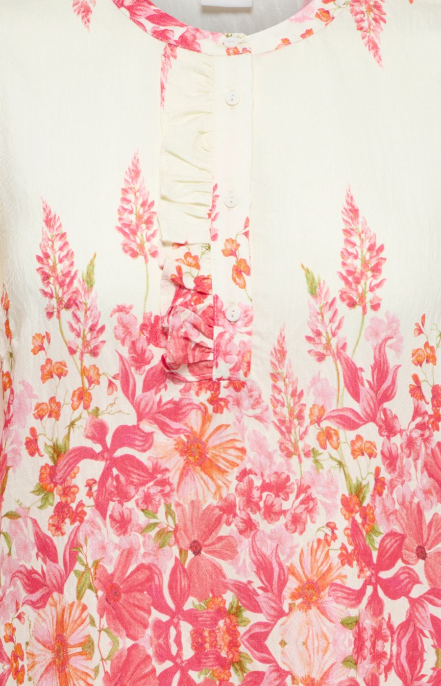 Close-up of a floral patterned garment with pink and orange flowers on a white background.