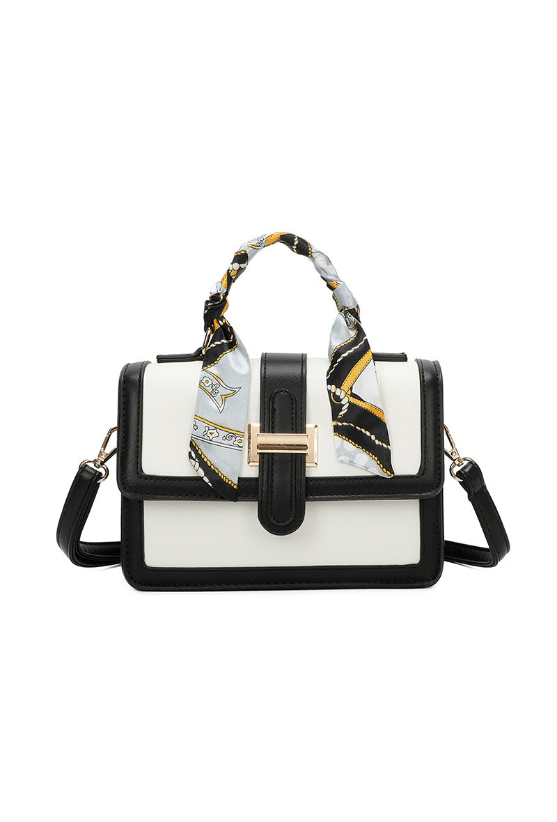 Handbag with a decorative scarf on a white background