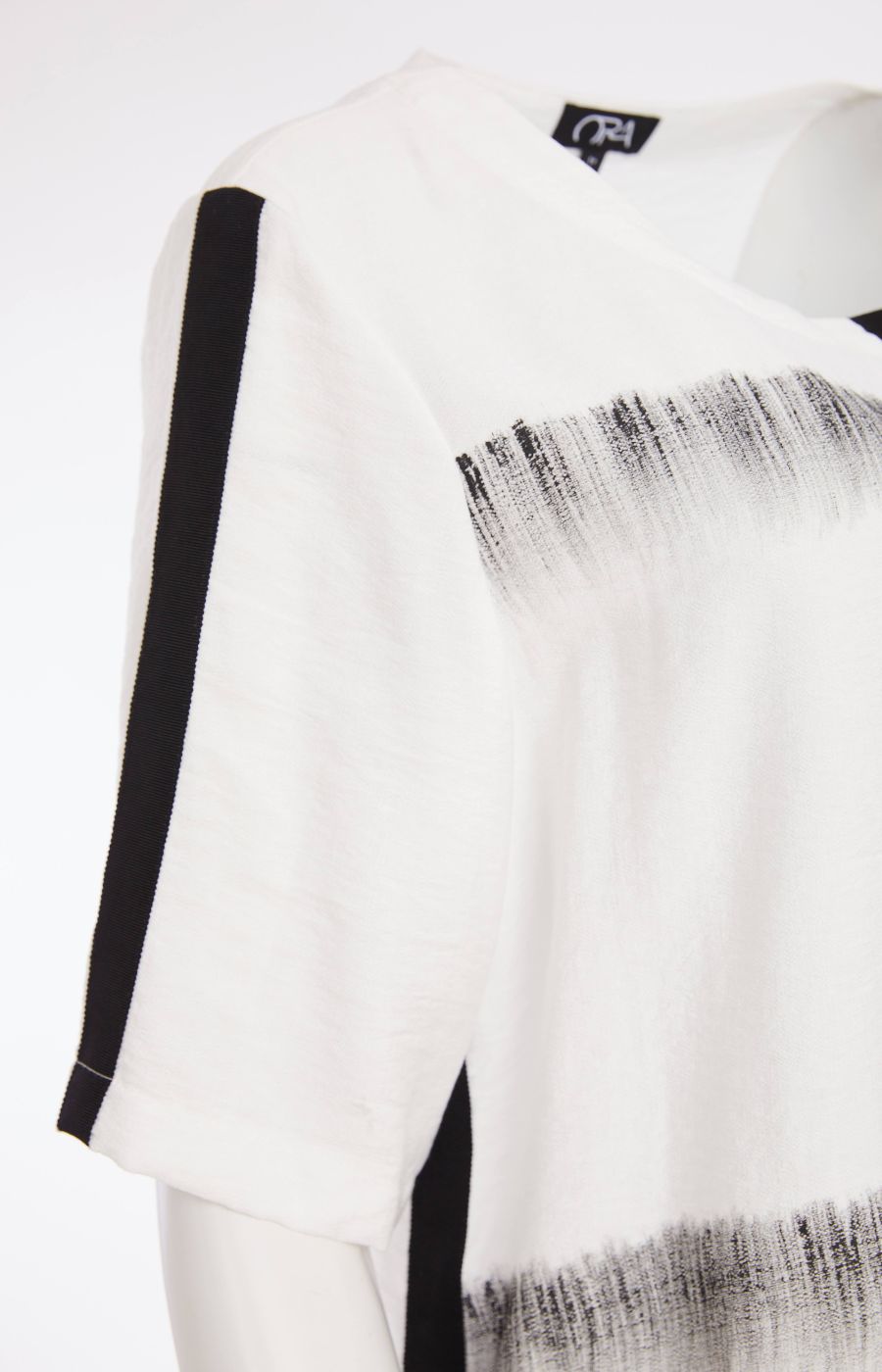 The Ora Blouse in White with Black, a white blouse with black patterns, with a round neckline, 1/2 length sleeves and a relaxed fit  