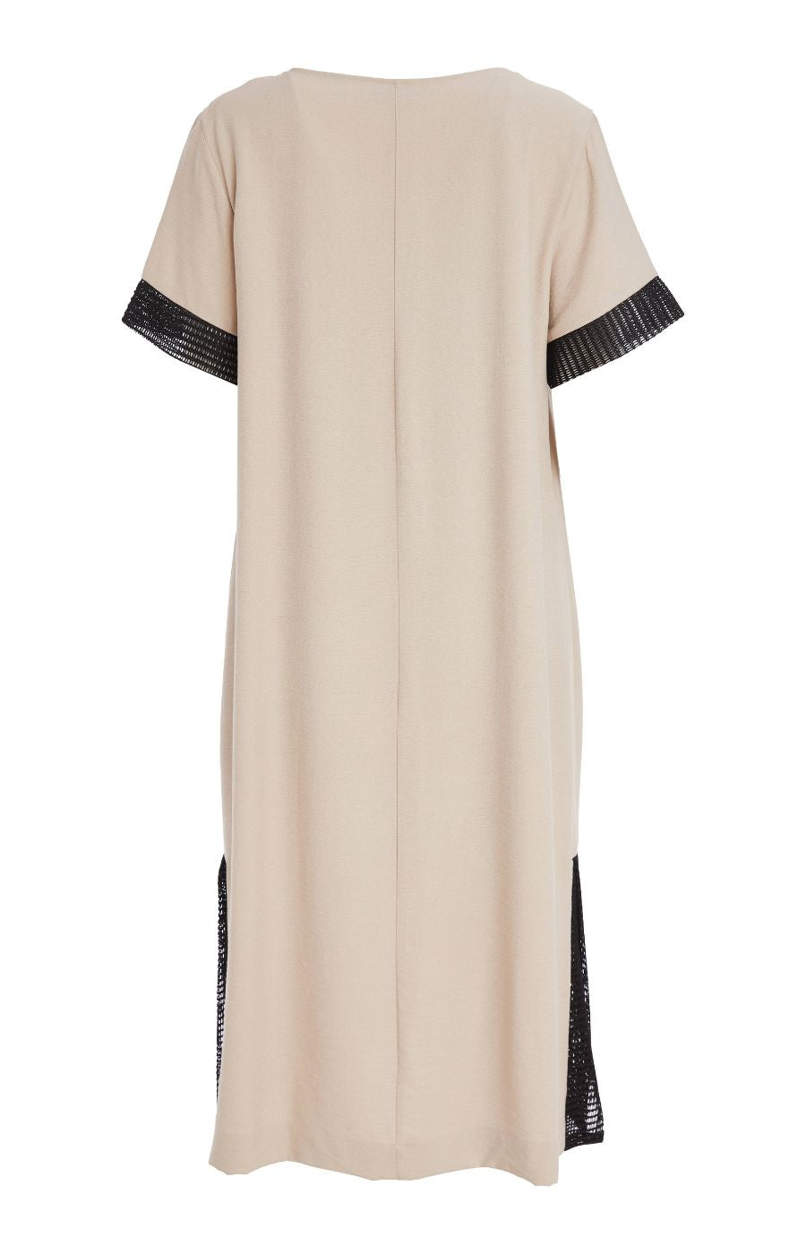 Woman wearing the Ora Front Pocket Dress in Beige, a beige midi dress with black mesh accents on the cuffs of the short sleeves and side slits, has a round neckline, large front pocket, discreet side pockets and necklace included in a minimal indoor setting 