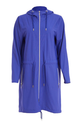 Woman wearing the Ora Hooded Jacket in Blue, with the blue Ora travel trousers a blue outfit with a white background  
