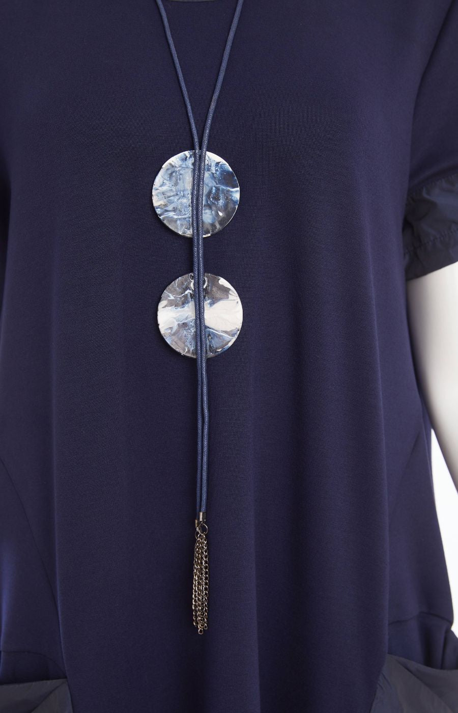 Woman wearing the Ora Side Pocket Dress in Navy, a navy blue dress with side pockets, round neckline and short sleeves, in a midi length.   
