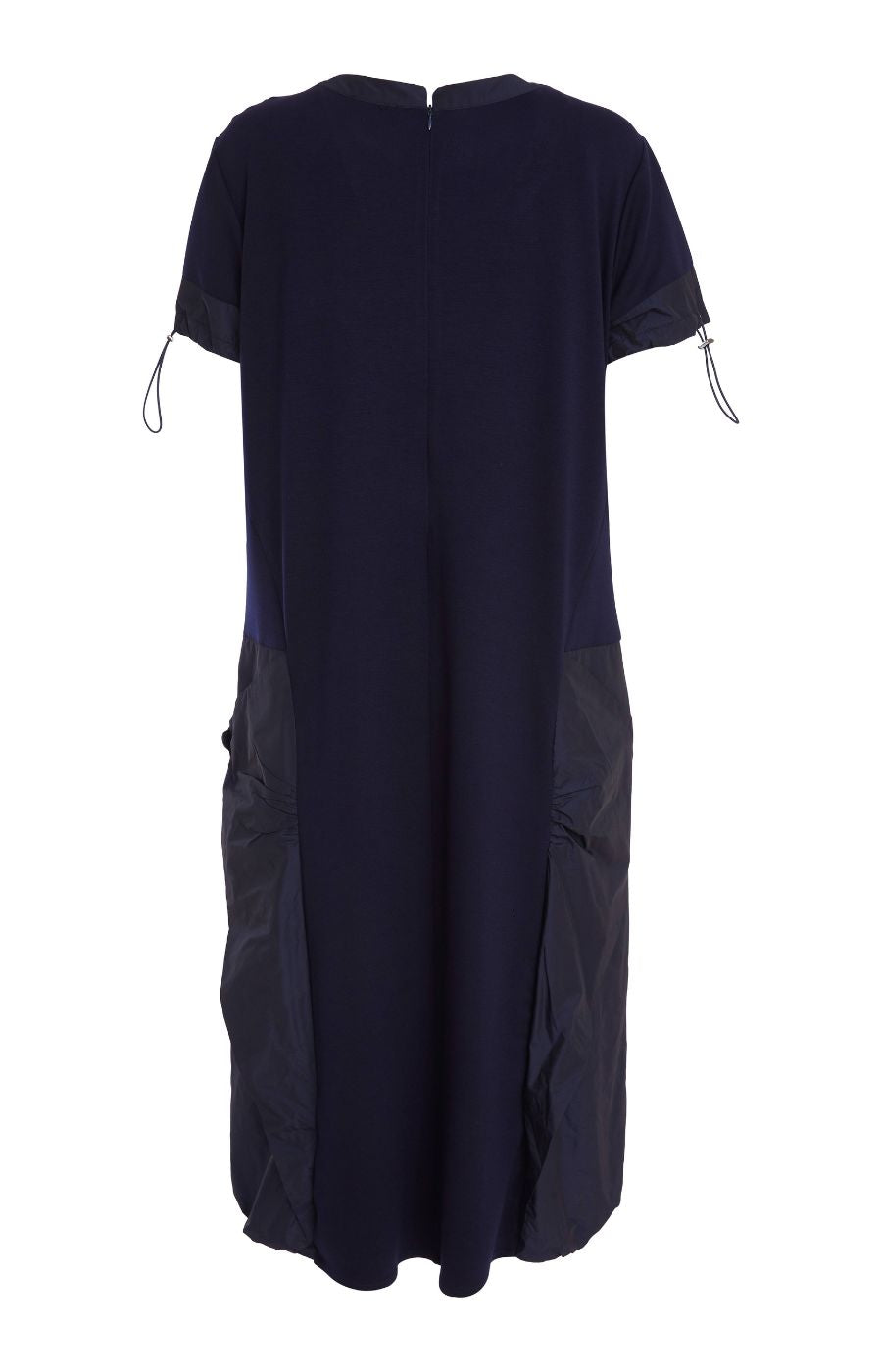 Woman wearing the Ora Side Pocket Dress in Navy, a navy blue dress with side pockets, round neckline and short sleeves, in a midi length.    