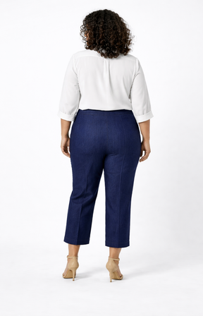 Person wearing a white blouse and navy jeans on a white background
