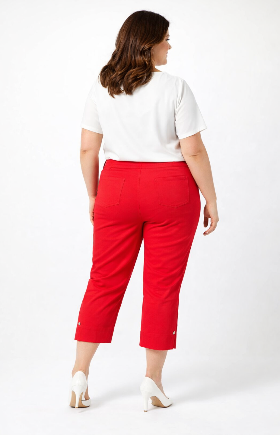 Person wearing a white top and red cropped trousers on a white background
