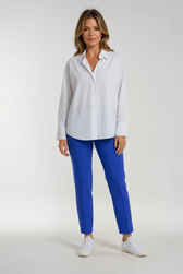 Woman wearing a white shirt and blue trousers on a white background