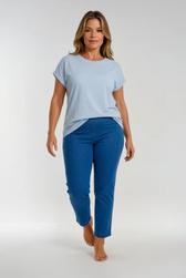 Woman wearing a light blue t-shirt and blue jeans on a white background
