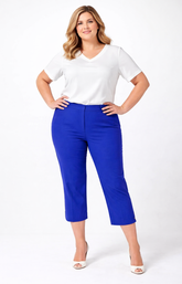 Woman wearing a white top and blue cropped trousers on a white background