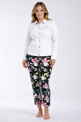 Woman wearing a white jacket and floral pants on a white background