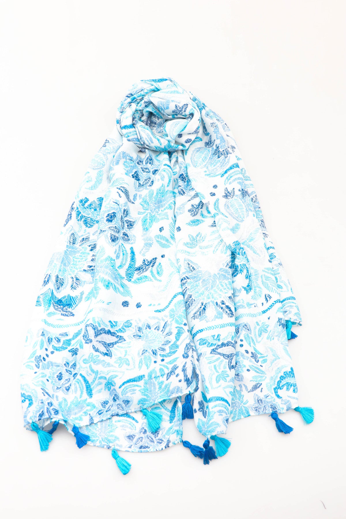 Blue and white floral patterned scarf with tassels on a white background